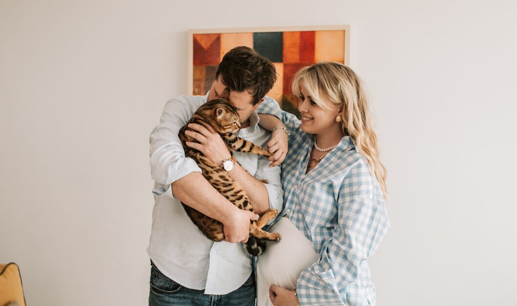 Tenant couple holding a pet cat inside a rented home, representing pets in tenancies under the Renters’ Rights Act 2025