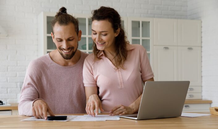 Homeowners reviewing property costs at home while deciding whether to sell or rent in the UK