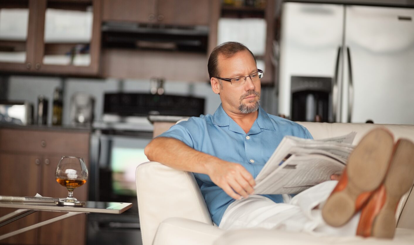 Landlord reading property news about ending a tenancy to sell a property